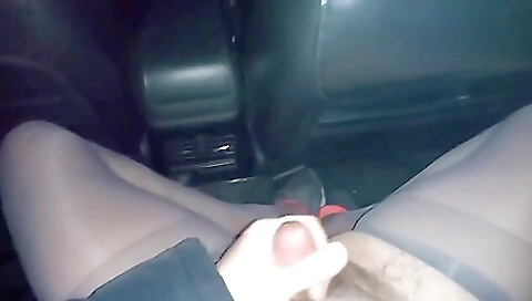 Teen in leather stockings riding a car on car door